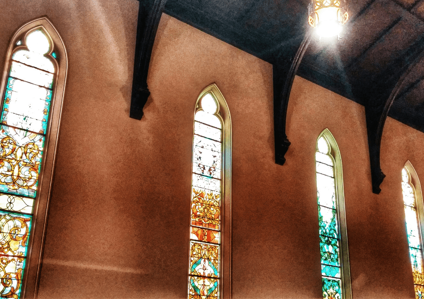 why do churches have stained glass windows