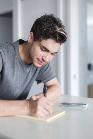 young man using spiritual journal